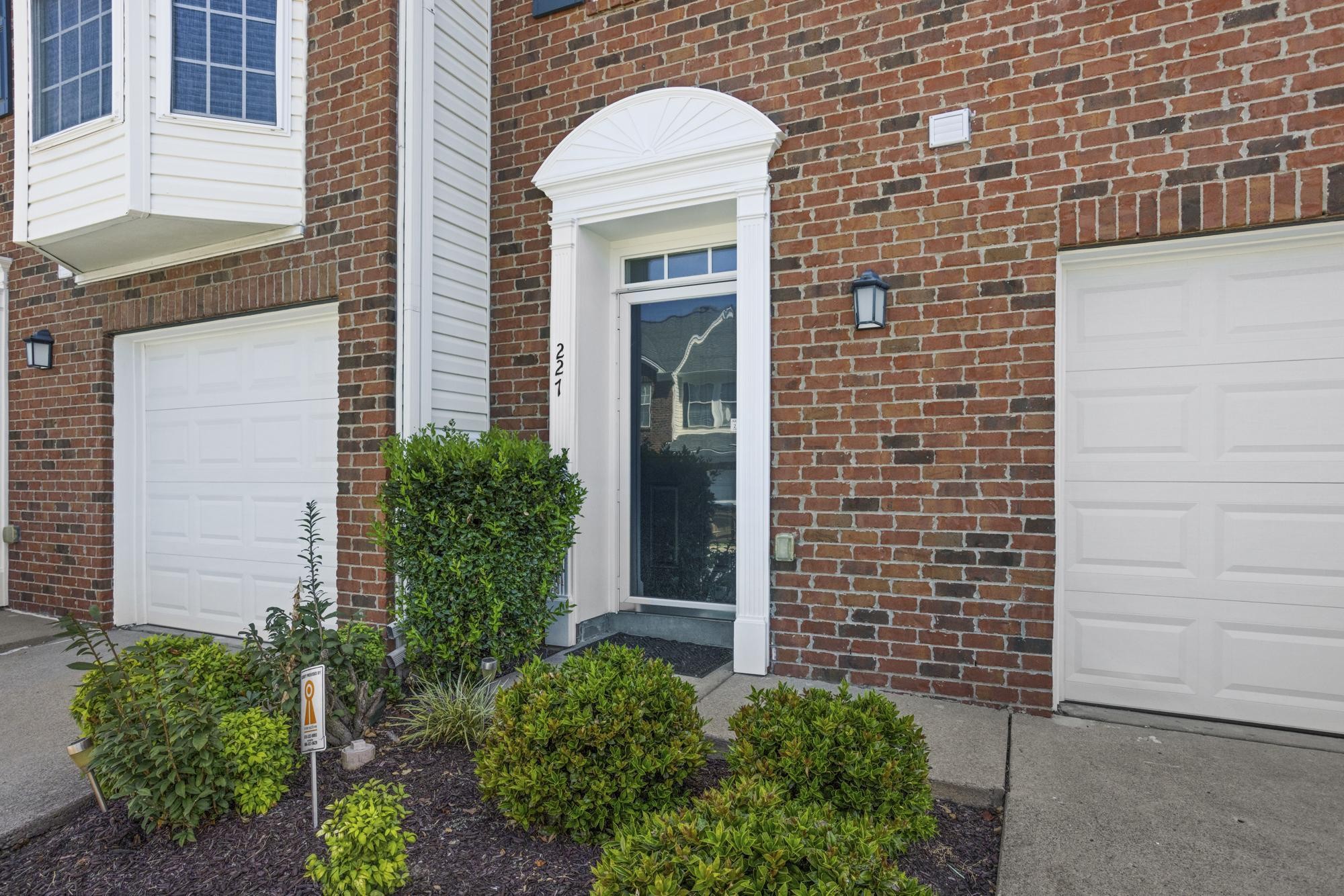 7277 Charlotte Pike, Unit 227 Nashville, TN 37209 - Photo 3 of 36 a view of a brick house with a large window and potted plants