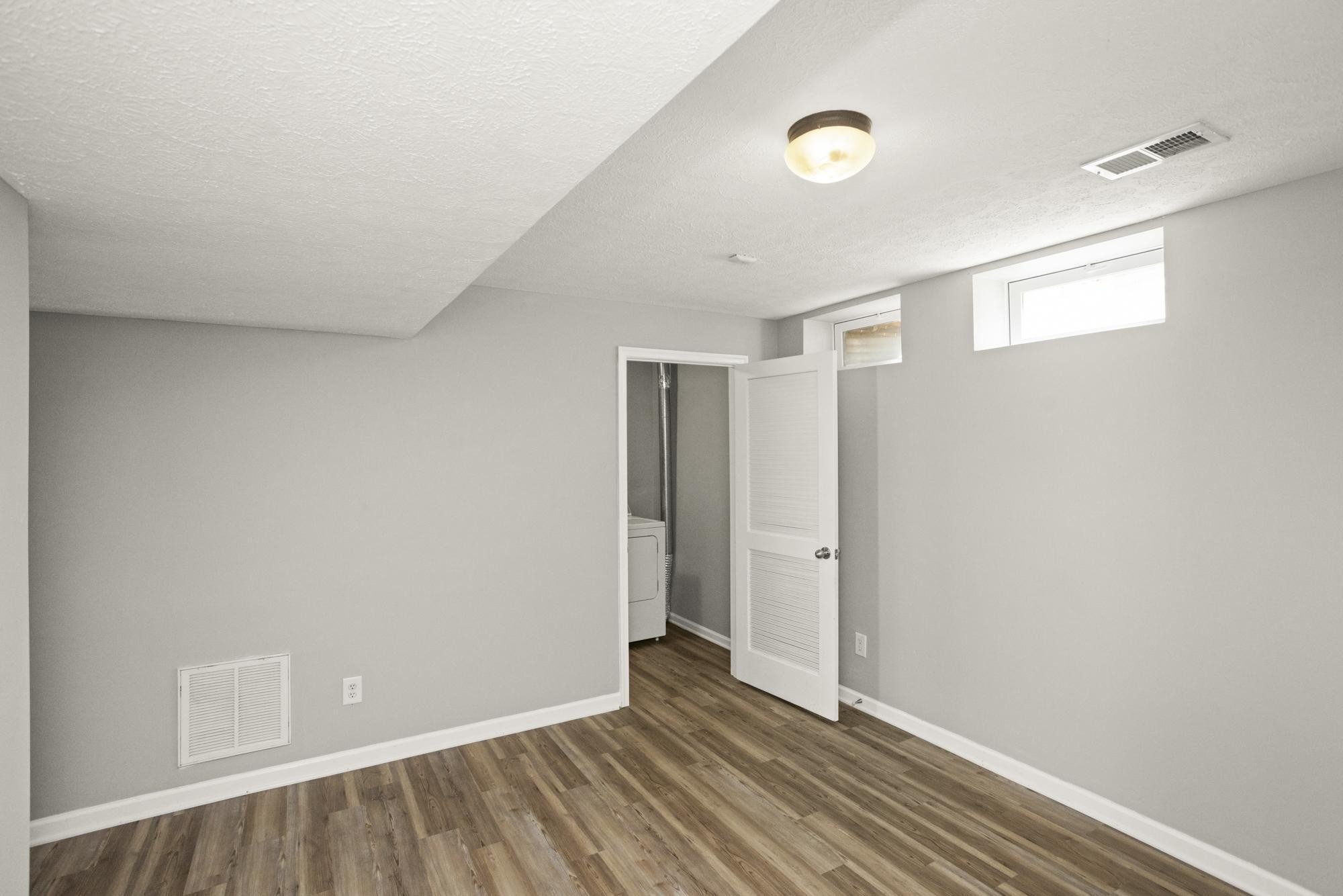 7277 Charlotte Pike, Unit 227 Nashville, TN 37209 - Photo 6 of 36 a view of an empty room with wooden floor