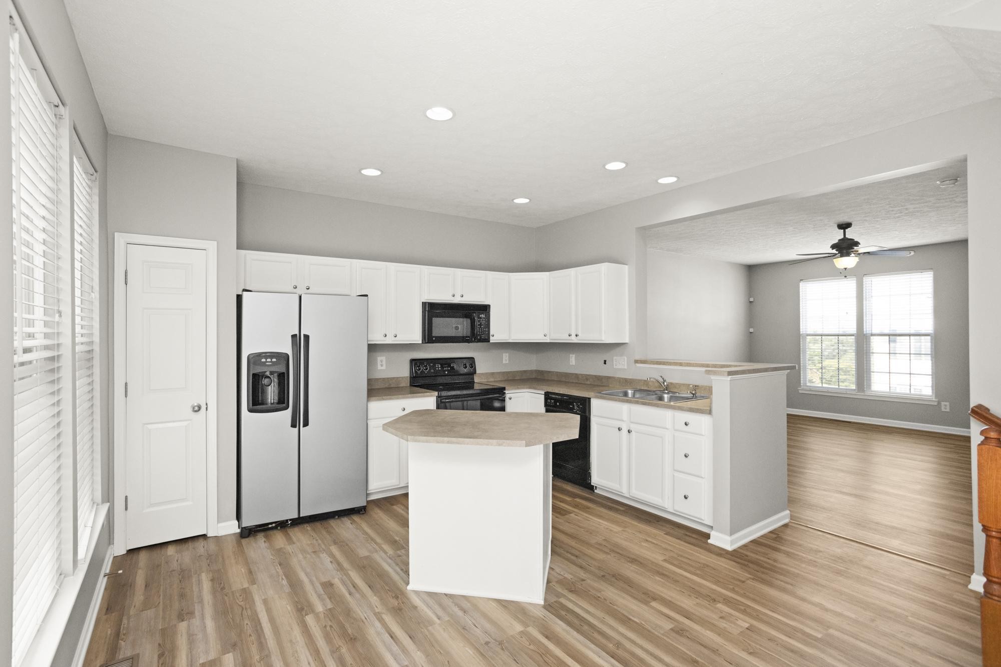 7277 Charlotte Pike, Unit 227 Nashville, TN 37209 - Photo 10 of 36 a kitchen with a refrigerator a stove top oven a sink and dishwasher with wooden floor