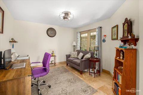 a living room with furniture a rug and a large window