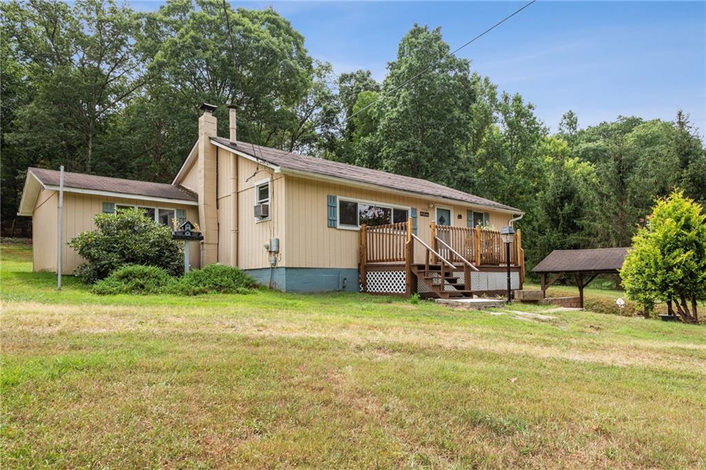 a view of a house with backyard and sitting area