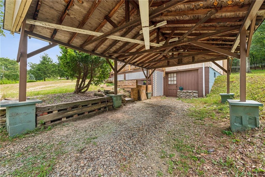 1110 Ross Mountain Park Road New Florence, PA 15944 - Photo 23 of 24 a view of a backyard with a wooden roof and a red chair