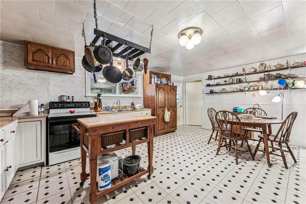 1110 Ross Mountain Park Road New Florence, PA 15944 - Photo 5 of 24 a kitchen with a table chairs and a stove