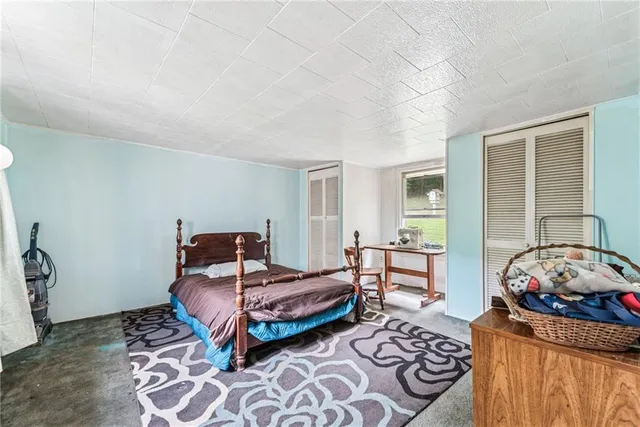 a bedroom with furniture and a window