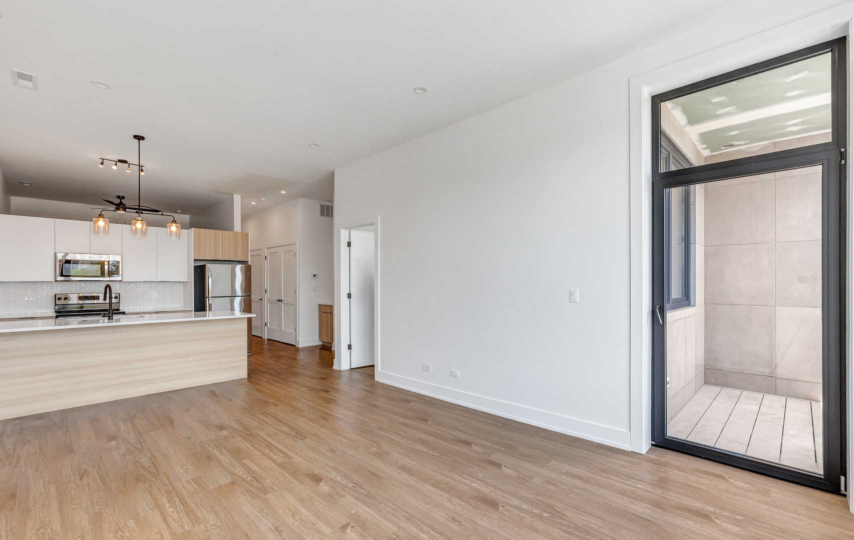 3312 North Halsted Street, Unit 2F Chicago, IL 60657 - Photo 3 of 17 a view of kitchen and hall with wooden floor