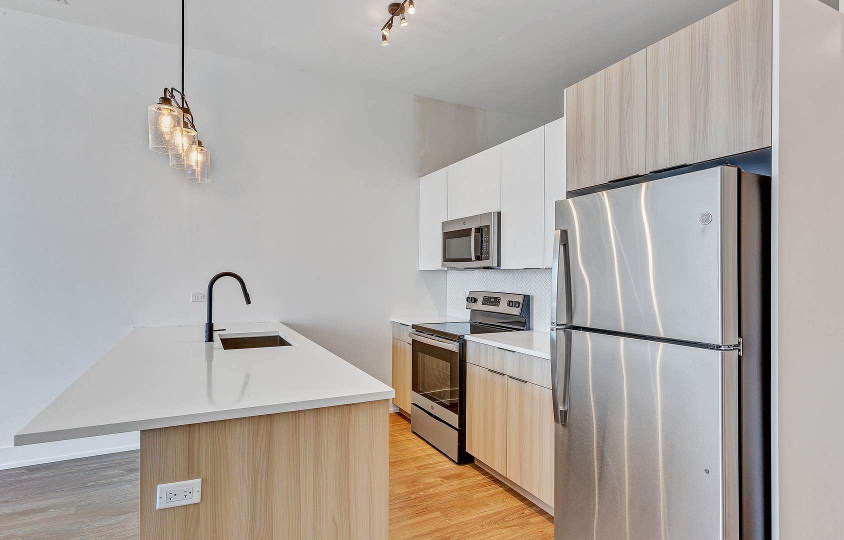 3312 North Halsted Street, Unit 2F Chicago, IL 60657 - Photo 6 of 17 a kitchen with stainless steel appliances a refrigerator sink and stove