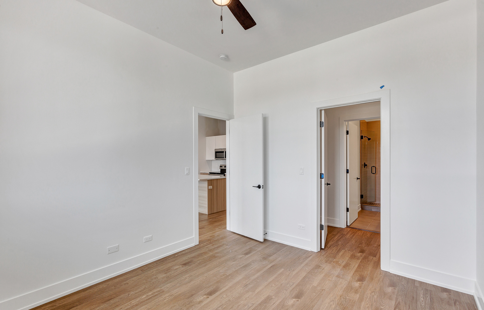 3312 North Halsted Street, Unit 2F Chicago, IL 60657 - Photo 10 of 17 a view of an empty room with wooden floor