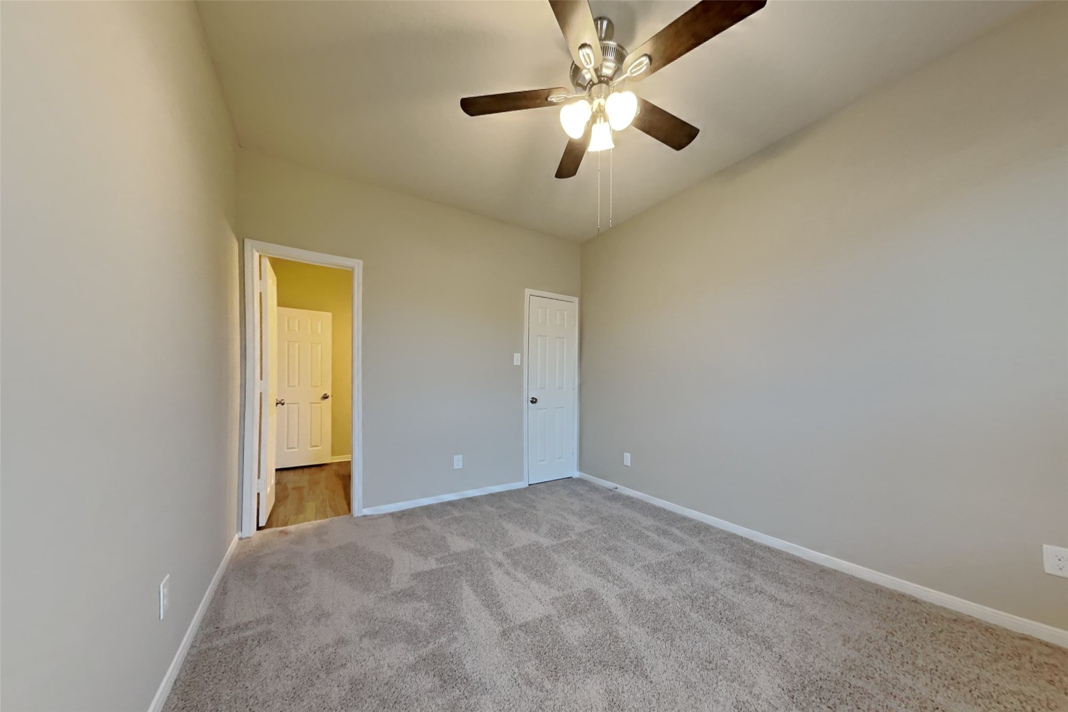 2411 Lofty Falls Court Spring, TX 77386 - Photo 14 of 23 an empty room with a chandelier fan and a ceiling fan