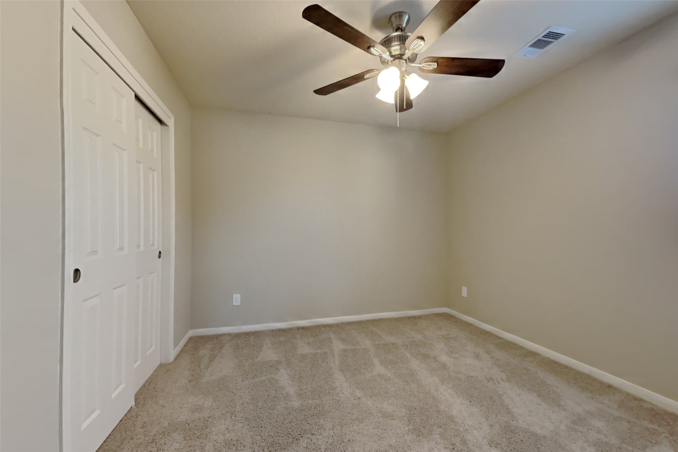 2411 Lofty Falls Court Spring, TX 77386 - Photo 16 of 23 an empty room with a chandelier fan and windows