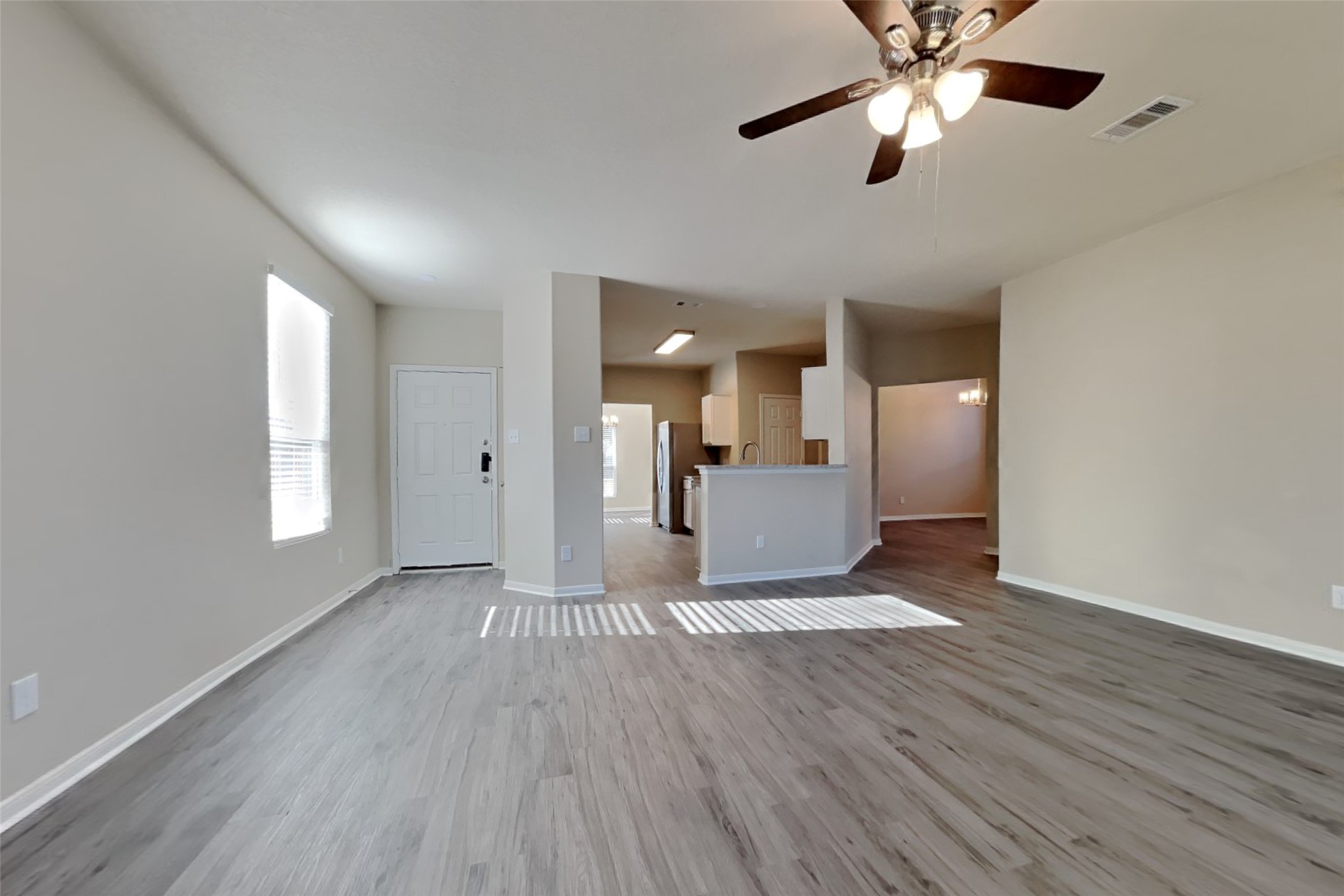2411 Lofty Falls Court Spring, TX 77386 - Photo 3 of 23 a view of a kitchen with wooden floor and a ceiling fan