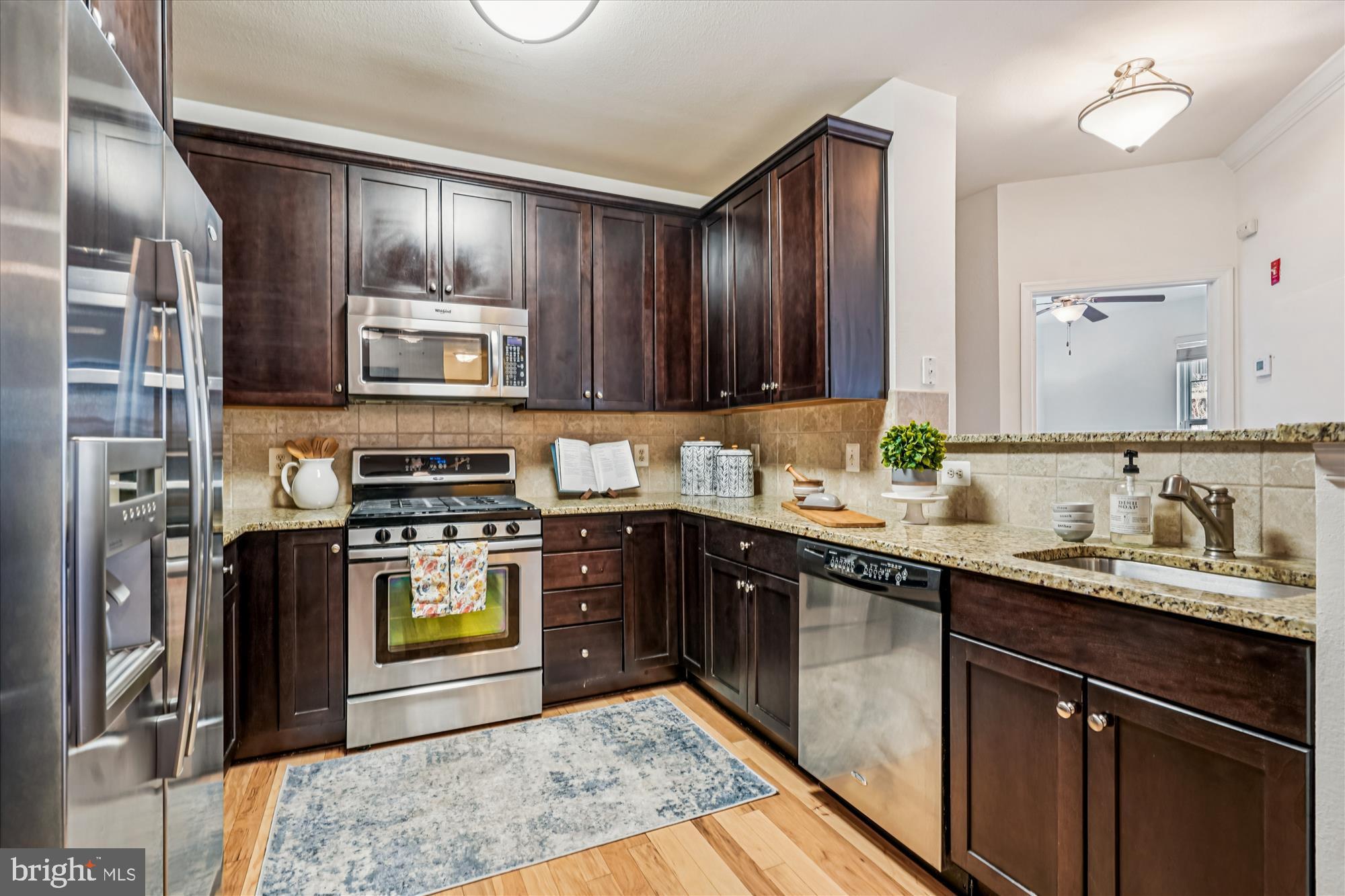 11750 Old Georgetown Road, Unit 2313 Rockville, MD 20852 - Photo 17 of 59 a kitchen with stainless steel appliances granite countertop a sink stove and refrigerator