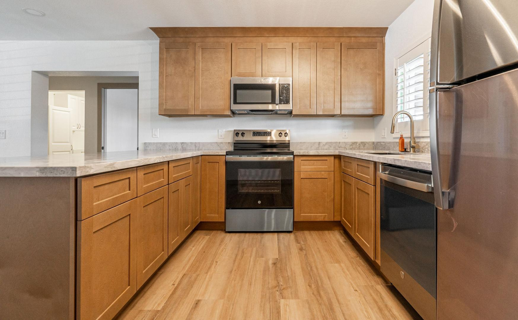 5739 West Monte Vista Road Phoenix, AZ 85035 - Photo 3 of 23 a kitchen with stainless steel appliances granite countertop a stove a sink and a refrigerator