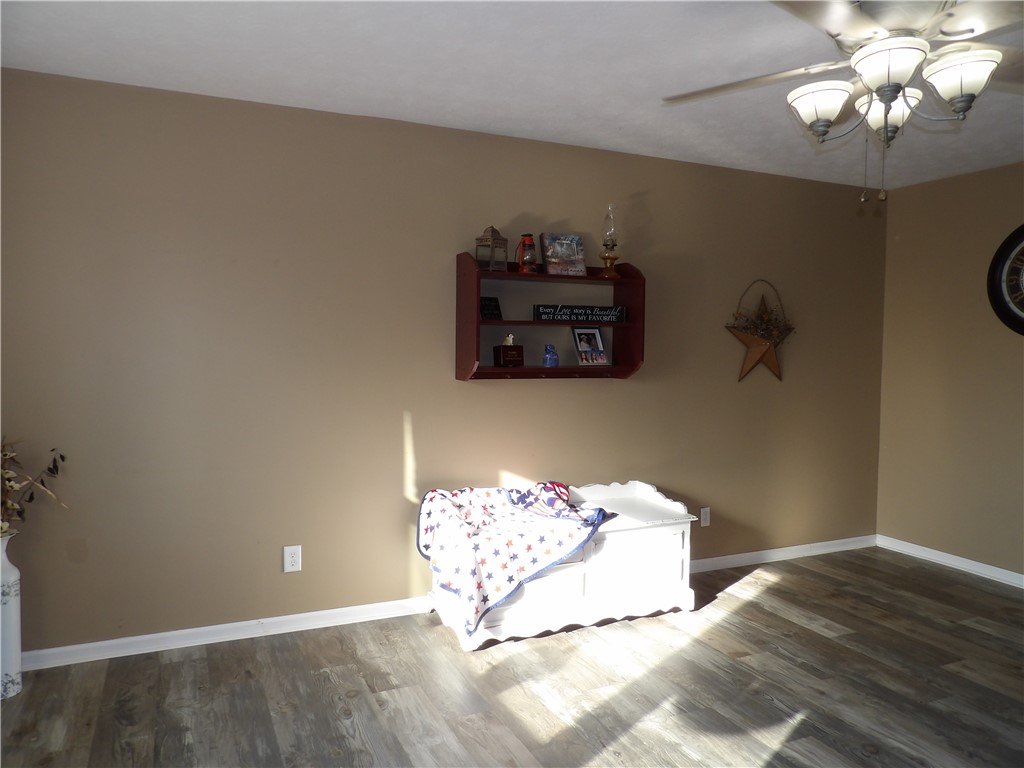 4505 North Alcony Conover Road Conover, OH 45317 - Photo 56 of 64 This inviting space features modern flooring and a classic ceiling fan, offering comfort and style.