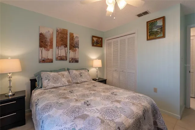 a bedroom with a bed and a lamp