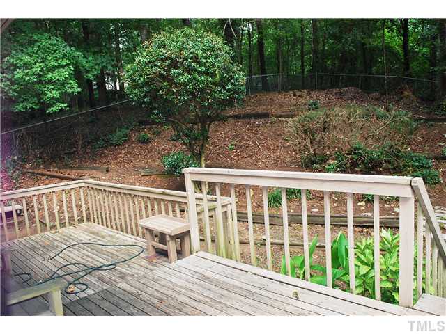 4540 Kaplan Drive Raleigh, NC 27606 - Photo 13 of 17 very large deck, step down to more deck! fenced yard is terraced on this side.
