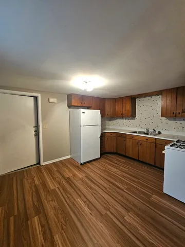 a view of a kitchen with a sink and a refrigerator