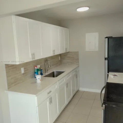 a kitchen with stainless steel appliances a sink a stove and a refrigerator