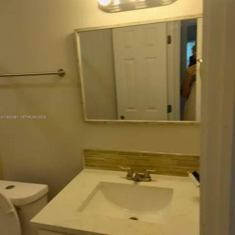 a bathroom with a sink and toilet