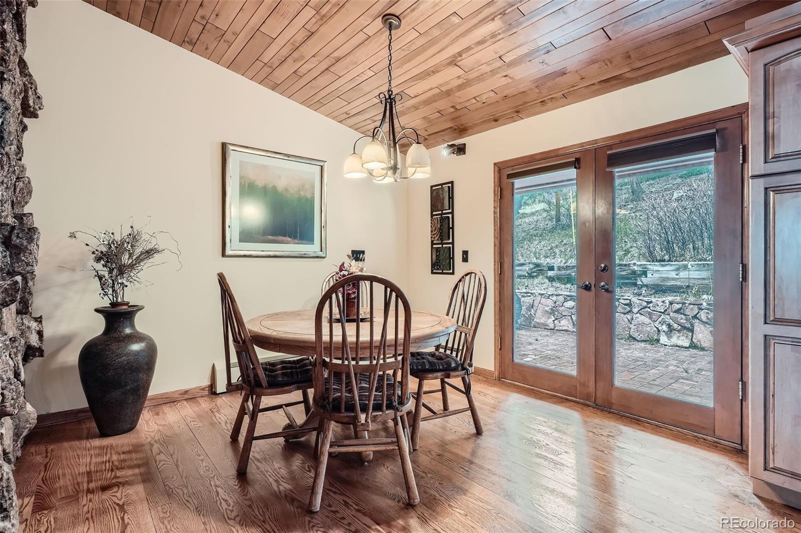 21191 Pleasant Park Road Conifer, CO 80433 - Photo 13 of 44 a view of a dining room with furniture window and wooden floor