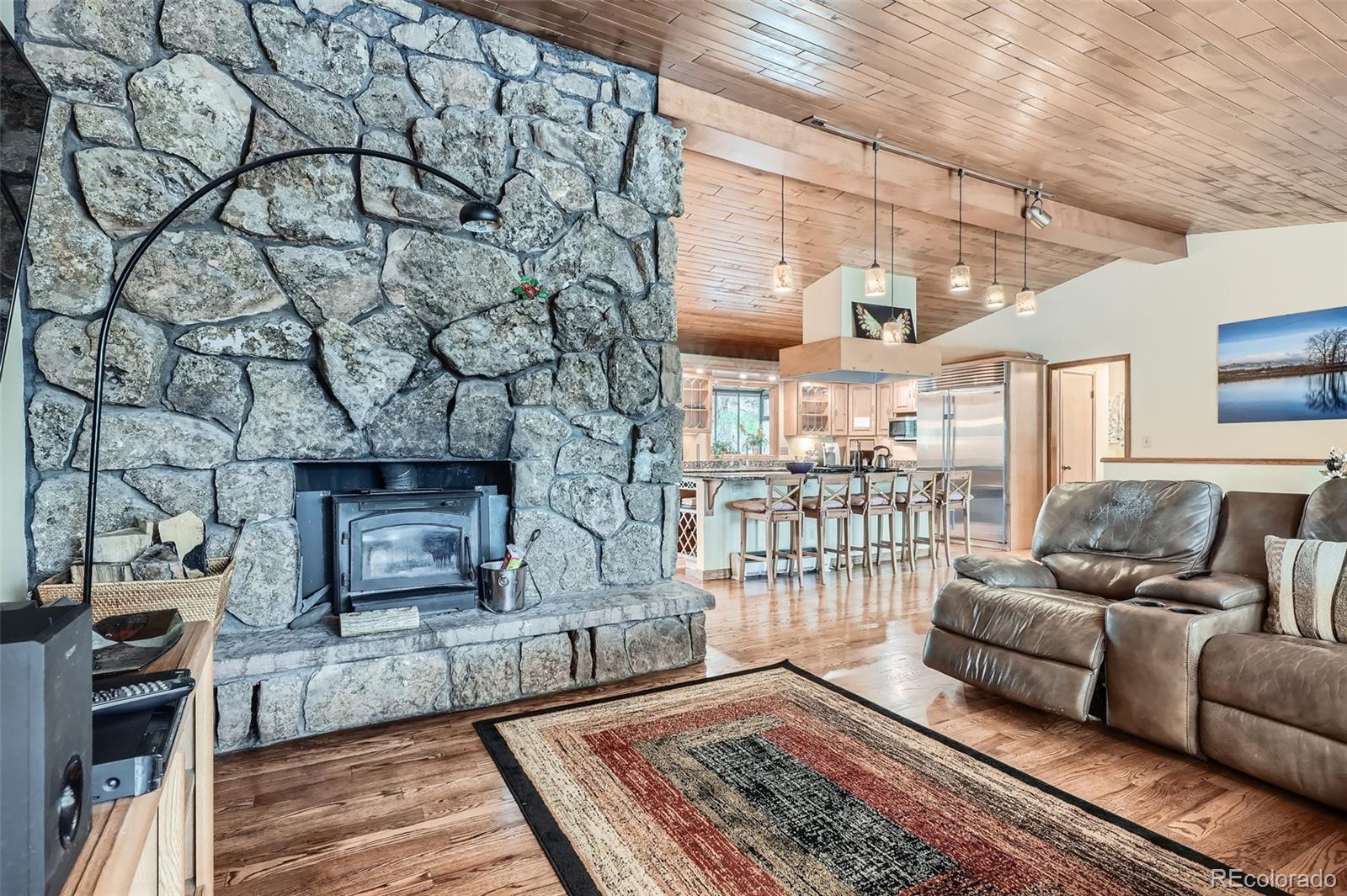 21191 Pleasant Park Road Conifer, CO 80433 - Photo 14 of 44 a living room with furniture and a fireplace