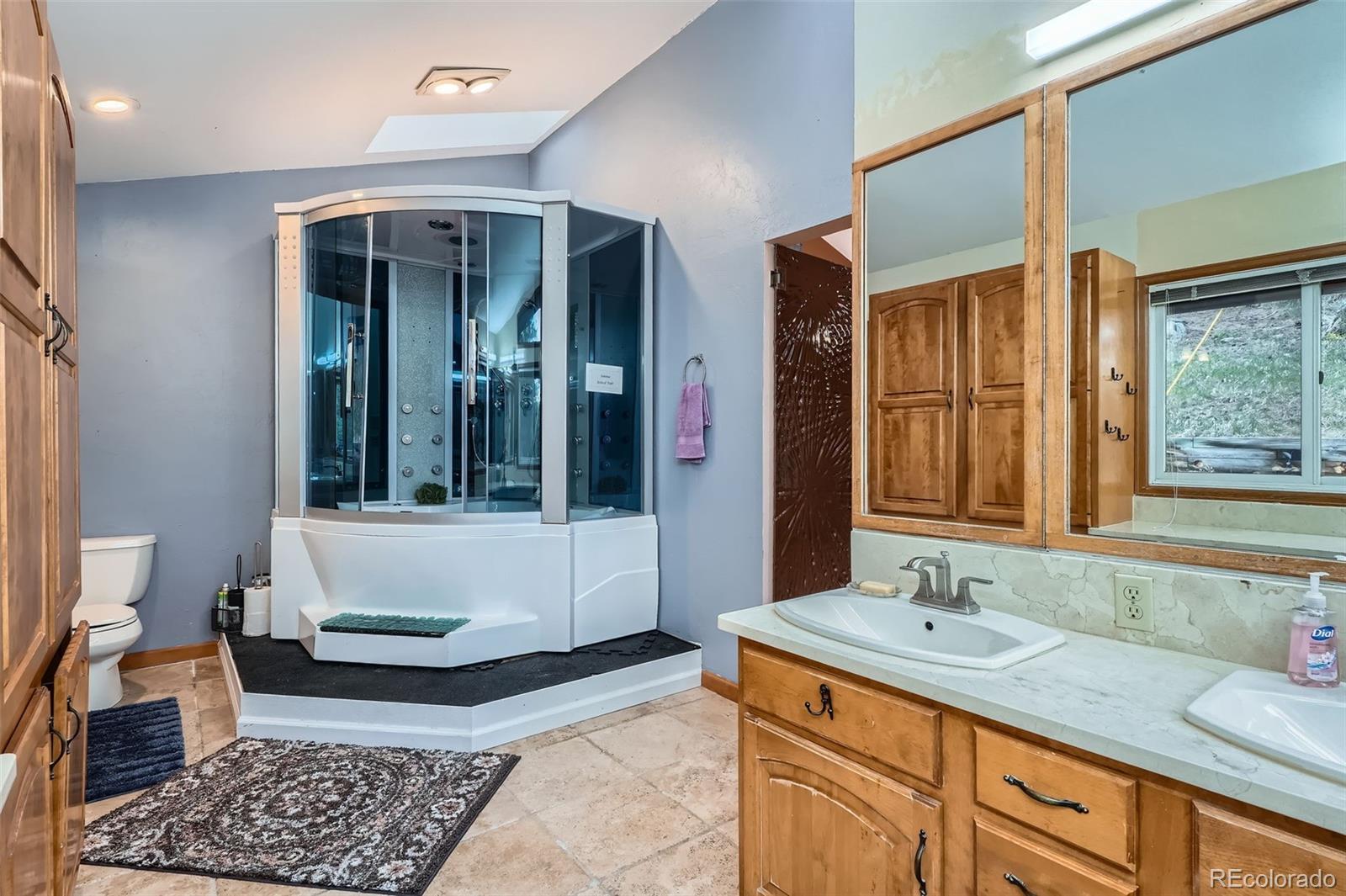 21191 Pleasant Park Road Conifer, CO 80433 - Photo 26 of 44 a bathroom with a tub sink and mirror