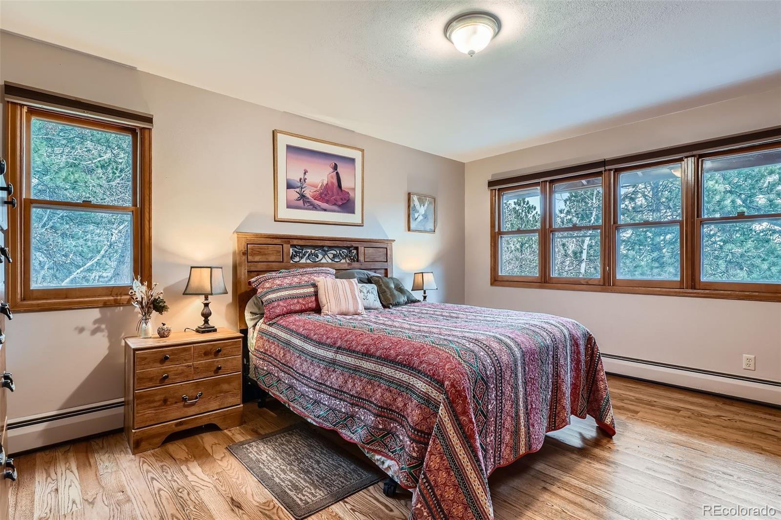 21191 Pleasant Park Road Conifer, CO 80433 - Photo 27 of 44 a bedroom with a bed and a window