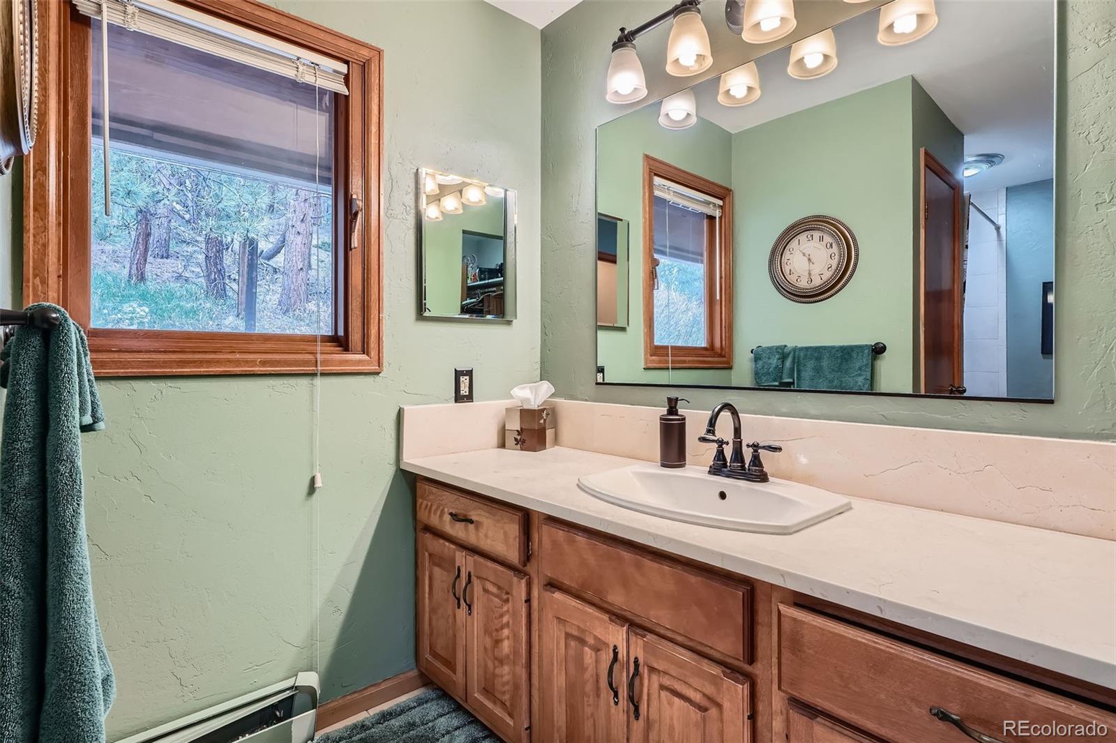 21191 Pleasant Park Road Conifer, CO 80433 - Photo 28 of 44 a bathroom with a sink and a mirror