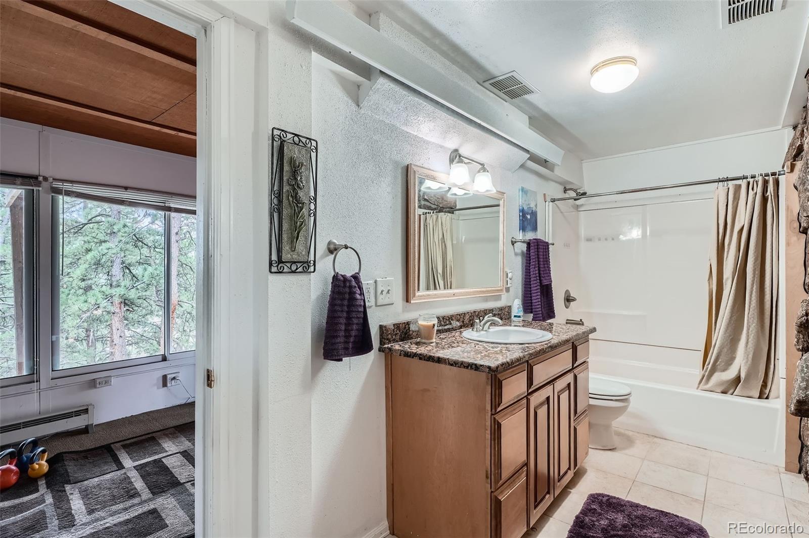 21191 Pleasant Park Road Conifer, CO 80433 - Photo 38 of 44 a kitchen that has a stove a sink and a refrigerator