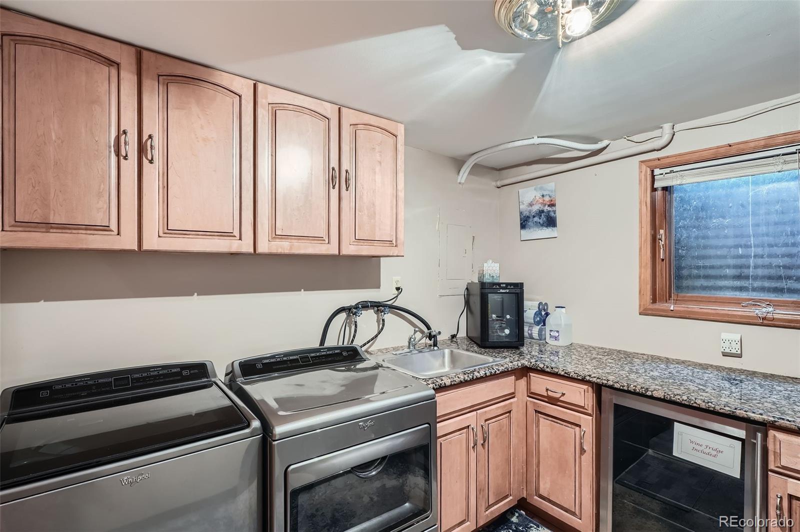 21191 Pleasant Park Road Conifer, CO 80433 - Photo 40 of 44 a kitchen with granite countertop a sink stainless steel appliances a counter space and cabinets