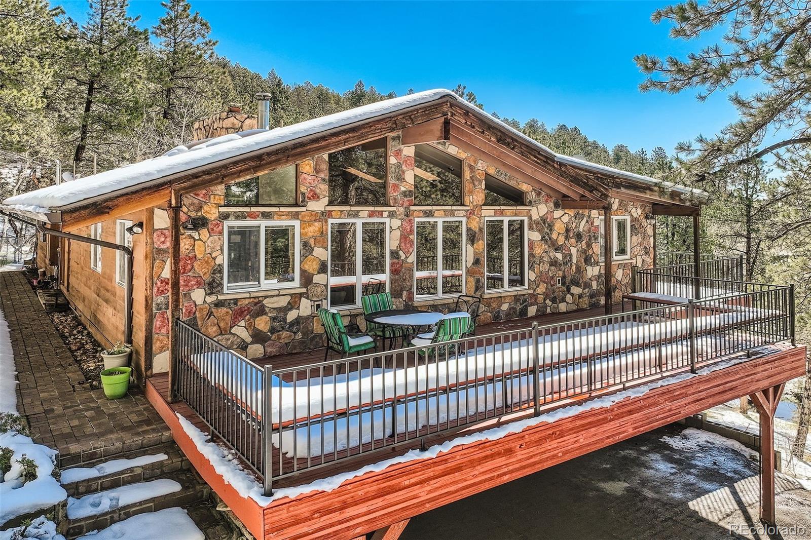 21191 Pleasant Park Road Conifer, CO 80433 - Photo 42 of 44 a view of a house with backyard and deck