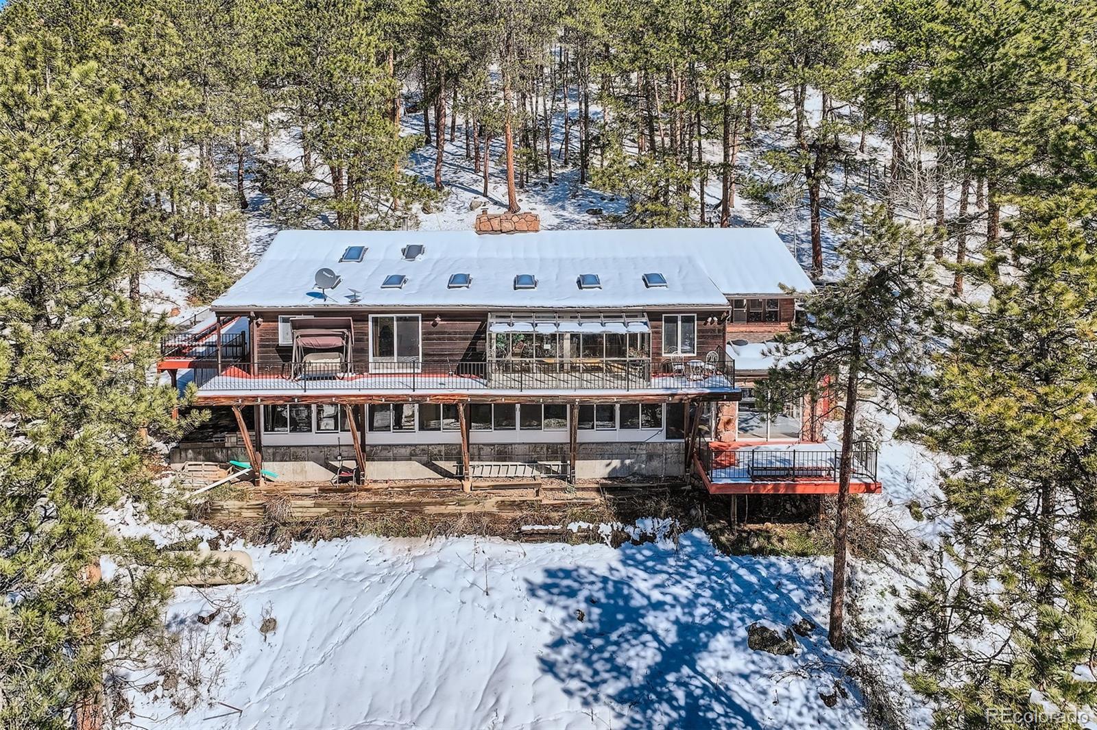 21191 Pleasant Park Road Conifer, CO 80433 - Photo 44 of 44 an aerial view of a house with swimming pool and sitting area