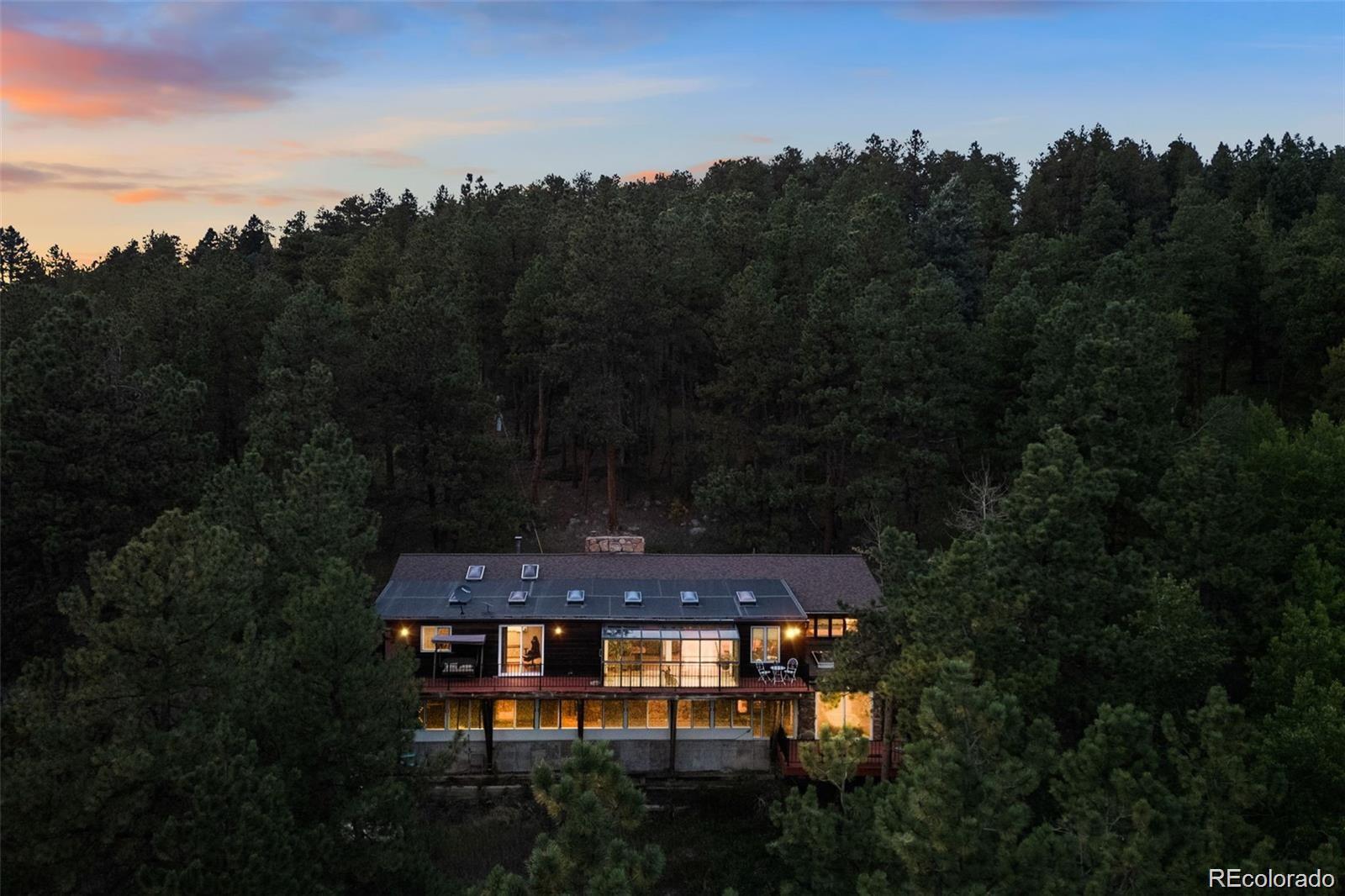 21191 Pleasant Park Road Conifer, CO 80433 - Photo 5 of 44 a view of a small yard in front of the house