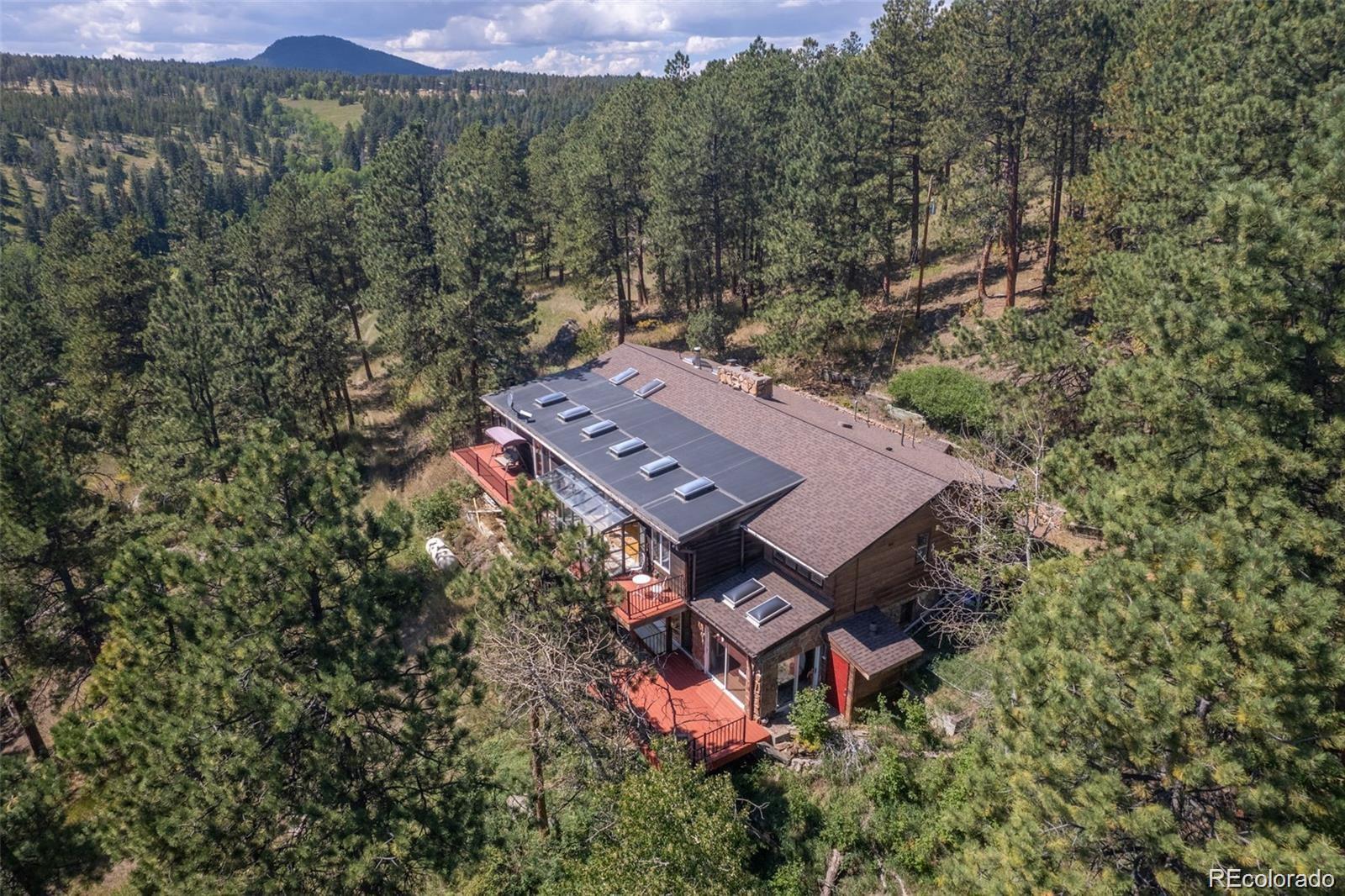 21191 Pleasant Park Road Conifer, CO 80433 - Photo 6 of 44 an aerial view of a house with a yard