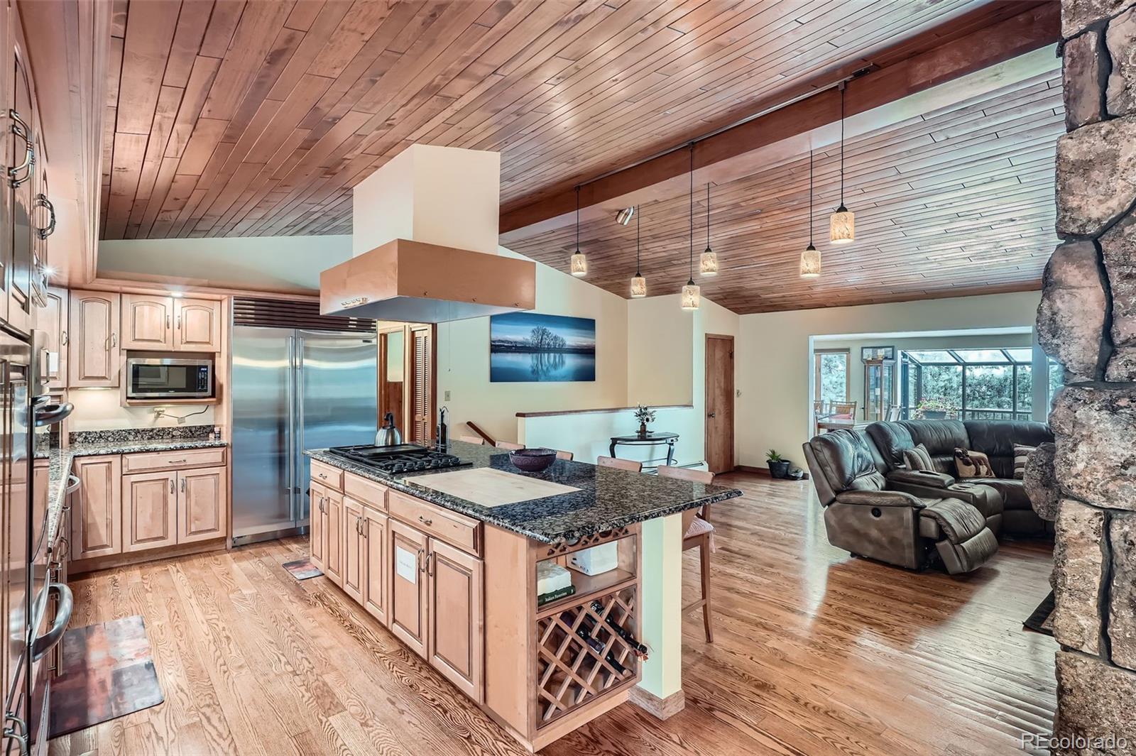 21191 Pleasant Park Road Conifer, CO 80433 - Photo 10 of 44 a kitchen with stainless steel appliances granite countertop a stove a sink dishwasher and cabinets with wooden floor