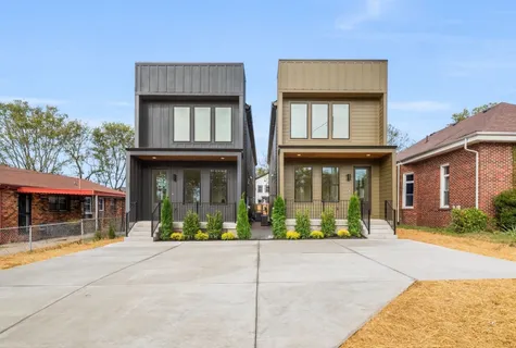 front view of a brick house with a yard