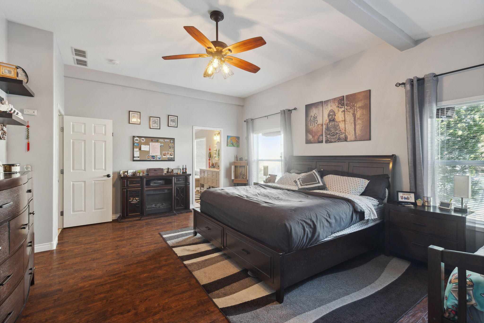 3798 Leonard Road Grants Pass, OR 97527 - Photo 15 of 62 a spacious bedroom with a bed and a chandelier