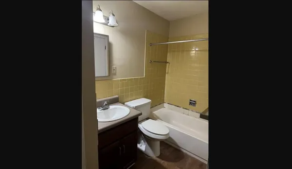 a bathroom with a toilet a sink and shower