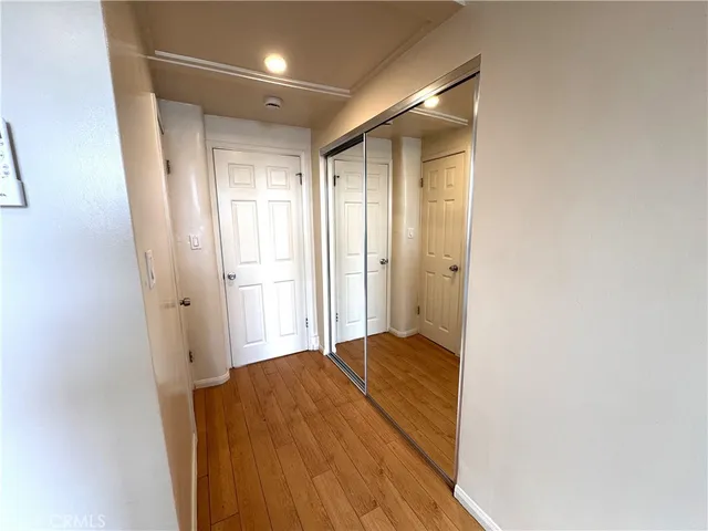 a view of a room with wooden floor and a bathroom