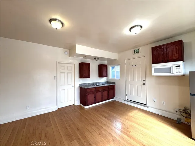 a large kitchen with stainless steel appliances kitchen island a large counter top and a stove top oven