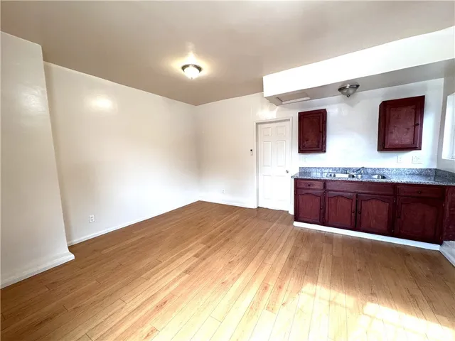 a spacious bathroom with a granite countertop sink and a mirror