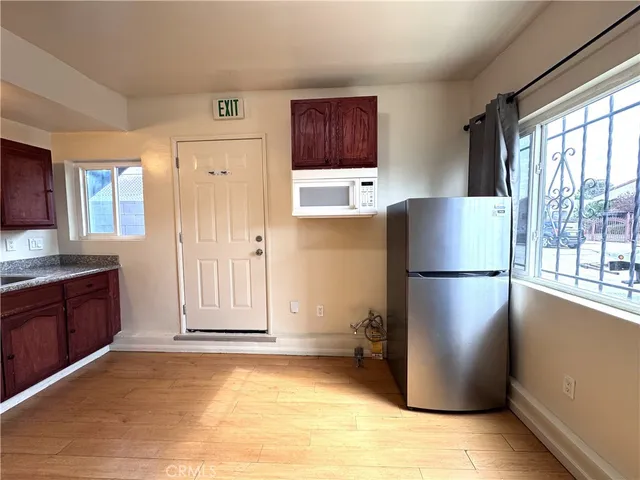 a refrigerator freezer sitting in a kitchen with stainless steel appliances granite countertop cabinets and a refrigerator