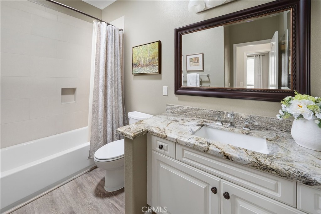 25808 Barnett Lane Stevenson Ranch, CA 91381 - Photo 14 of 38 a bathroom with a granite countertop sink and a mirror