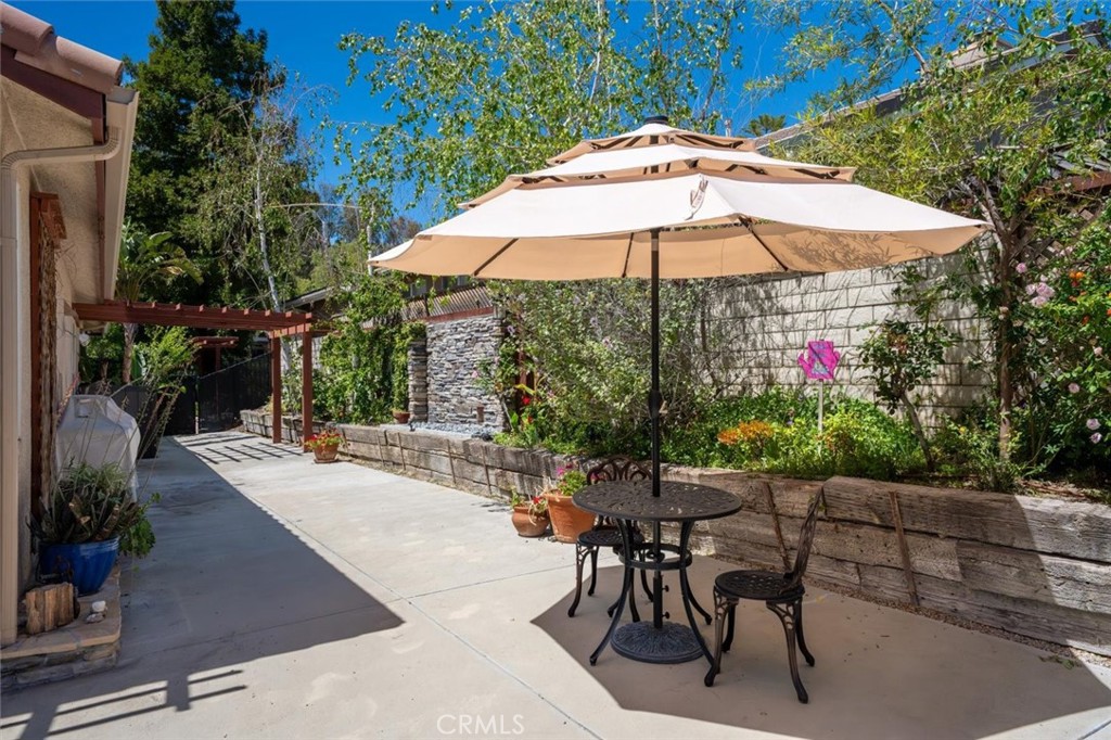 25808 Barnett Lane Stevenson Ranch, CA 91381 - Photo 27 of 38 an outdoor space with furniture and umbrella