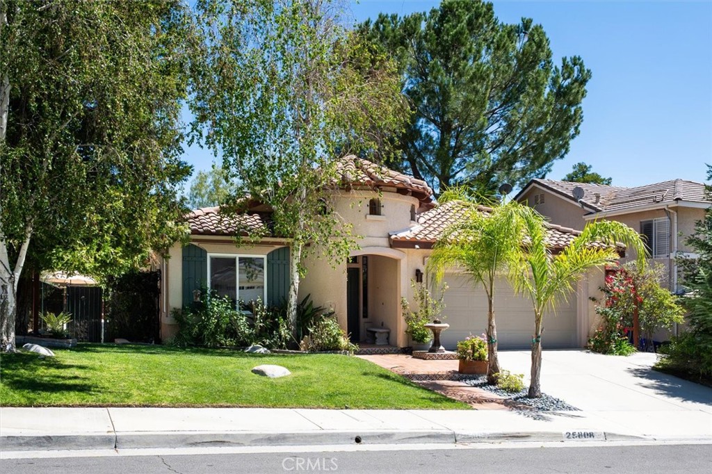 25808 Barnett Lane Stevenson Ranch, CA 91381 - Photo 32 of 38 a view of a white house with a yard and plants