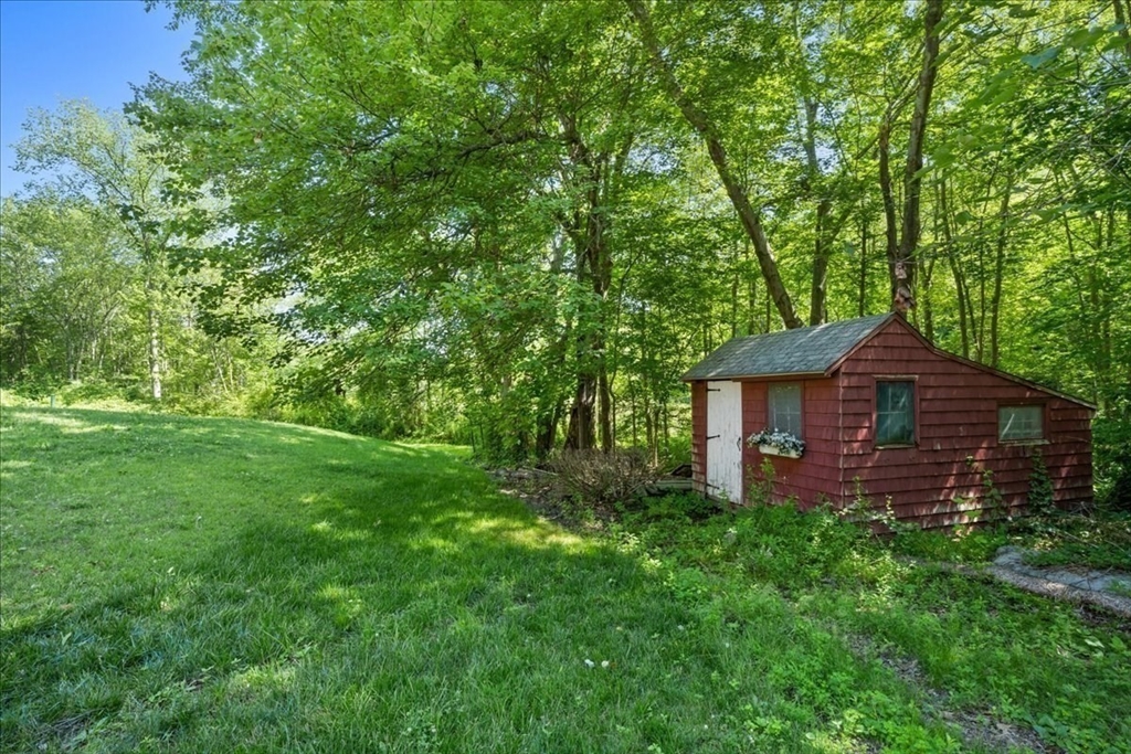 352 Hill Road Boxborough, MA 01719 - Photo 21 of 25 a view of a backyard with barn and large trees