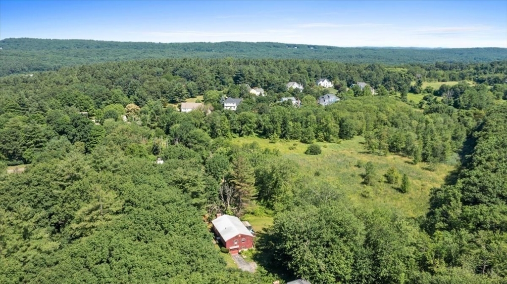 352 Hill Road Boxborough, MA 01719 - Photo 23 of 25 a view of a green field with lots of bushes