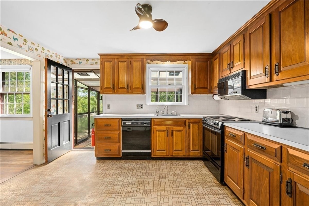 352 Hill Road Boxborough, MA 01719 - Photo 6 of 25 a kitchen with stainless steel appliances granite countertop a stove a sink and a microwave