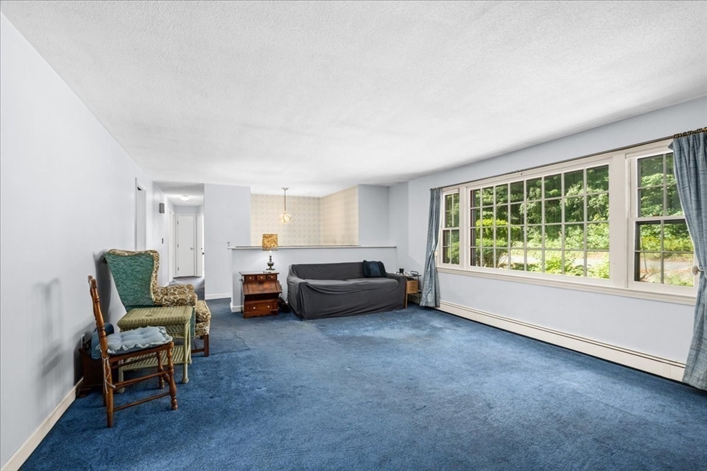 352 Hill Road Boxborough, MA 01719 - Photo 10 of 25 a living room with furniture and a floor to ceiling window