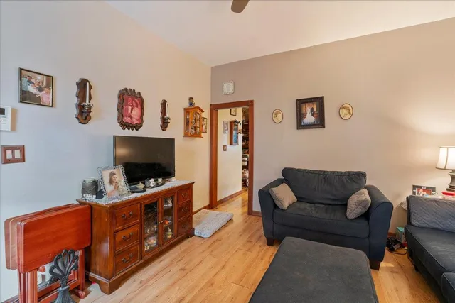 a living room with furniture a couch and paintings on the wall