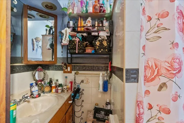 a view of backyard with table and chairs potted plants and a wooden fence